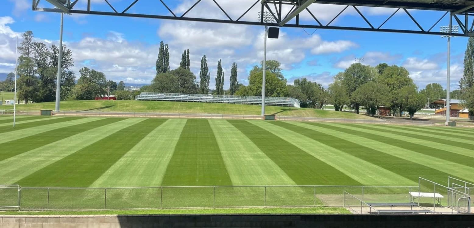 Sports field with stadium lighting and precision mow striping